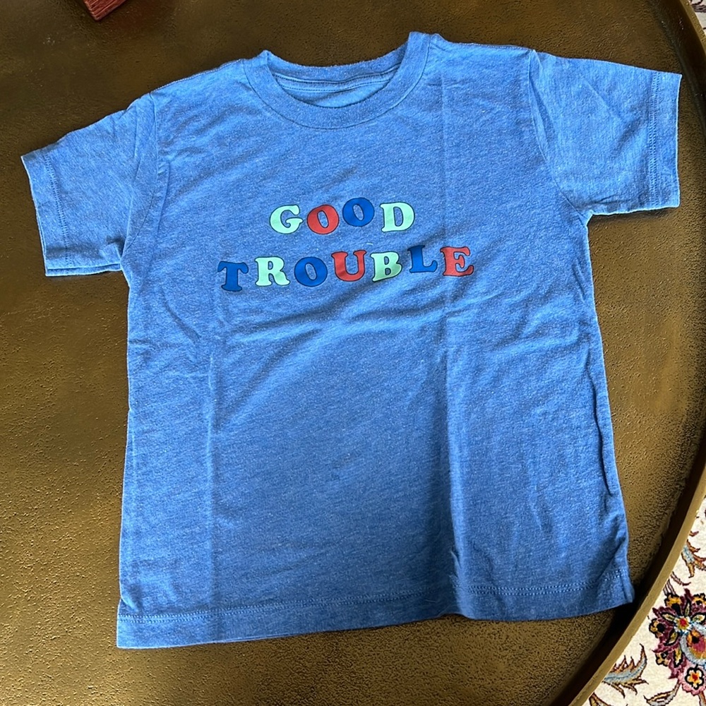 A blue shirt with words Good Trouble. Size (5T). Used, but in good condition.